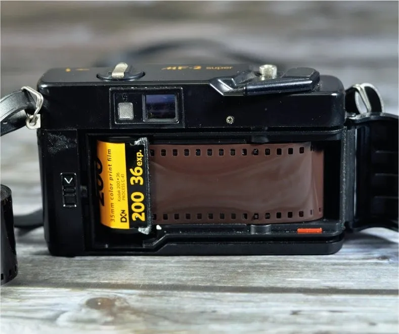 A 35mm film camera with a roll of colour film