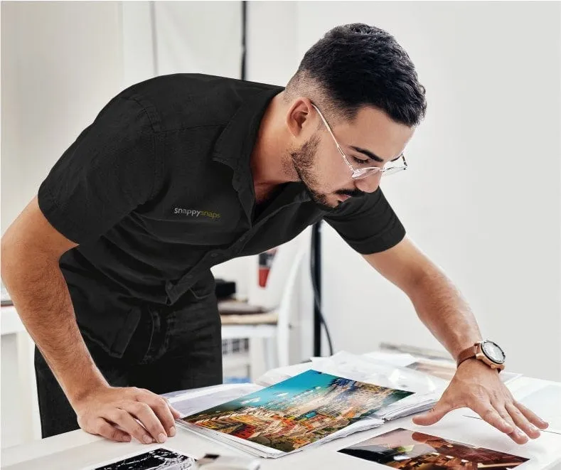 A Snappy Snaps colleague checking developed photo prints
