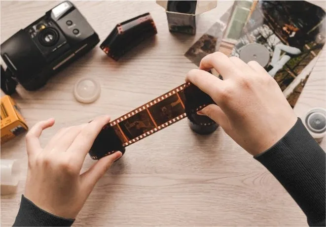 A developed film negative strip being handled