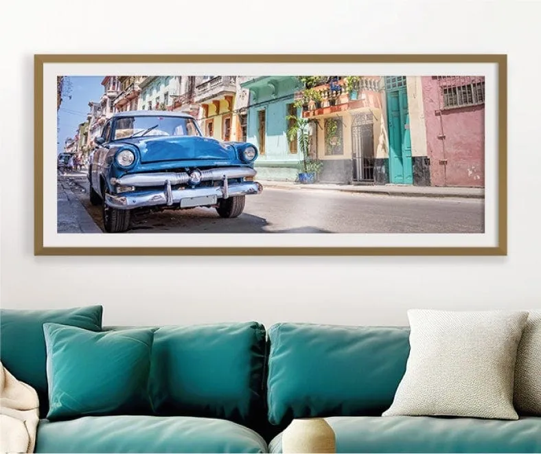 A framed print hanging above a living room sofa