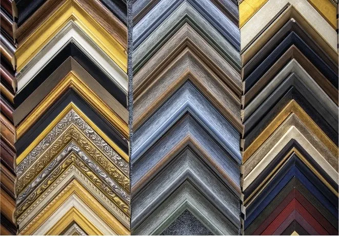 Rows of picture frame moulding samples in different colours and finishes