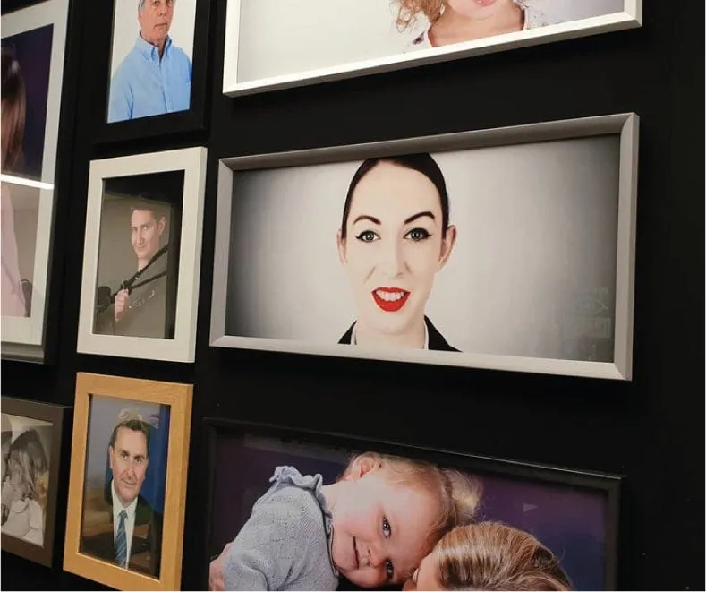 A wall of framed photographs and artwork