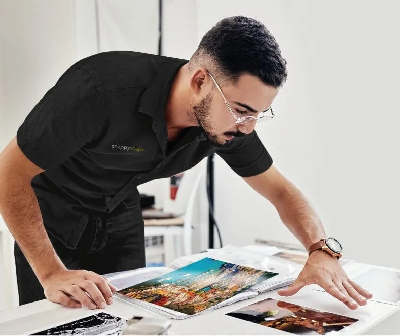 A Snappy Snaps colleague running a print job in store
