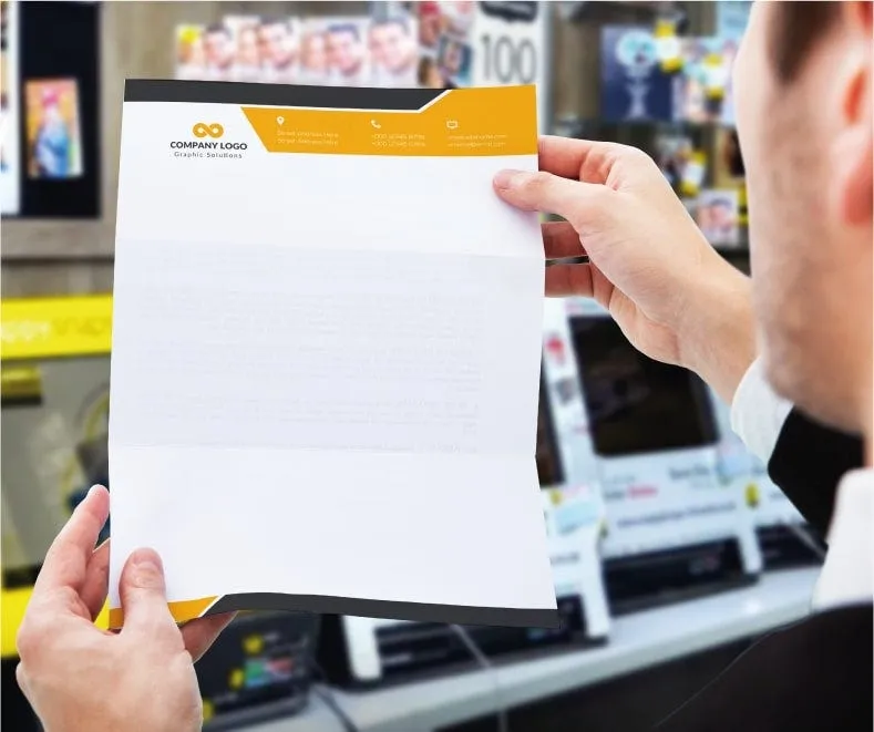 A printed letterhead being held up